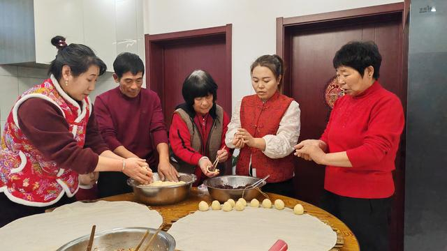 2025年12月31日晚，王宝维一家在一起包饺子。 新华社发（李健鹏摄）