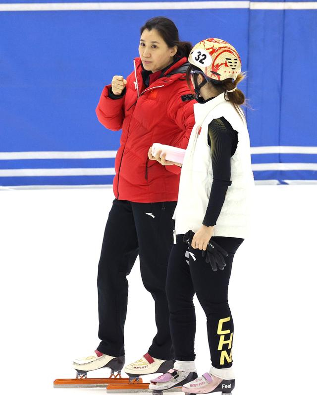 ↑ 中国短道速滑队教练张晶（左）在训练中为队员杨婧茹加油。 新华社记者 张晨 摄