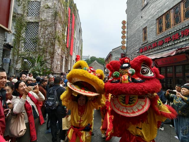 2月17日，市民在广西南宁市三街两巷历史文化街区观看舞狮表演。新华社发（喻湘泉摄）