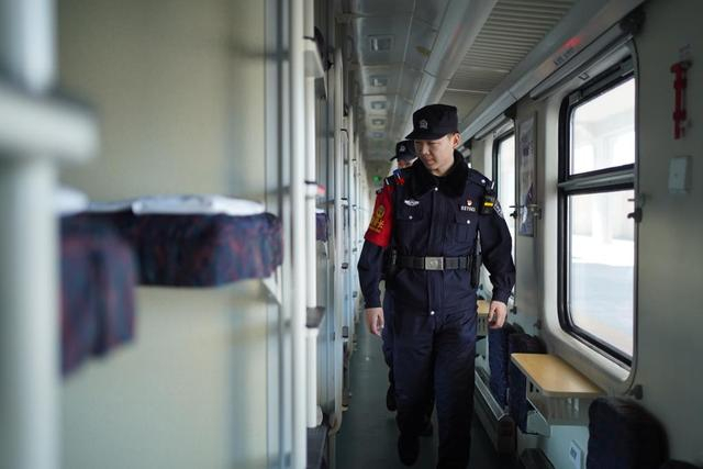 除夕（2月16日），通化铁路公安处乘警在列车上巡查。新华社发（刘春明摄）