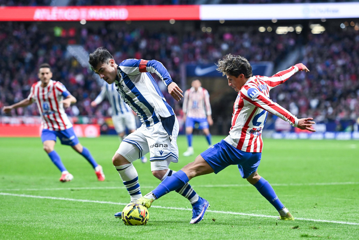 3月7日，马德里竞技队球员朱利亚诺·西蒙尼（右）和皇家社会队球员巴雷内切亚在比赛中拼抢。 新华社发（古斯塔沃·巴连特摄）