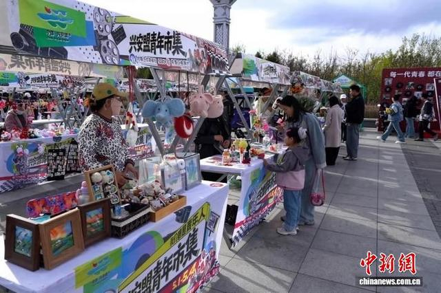 图为创意文创摊位前，游客驻足挑选手作好物。 刘新平 摄