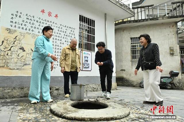 图为王琳达（左一）和家人一起饮用井水。中新社记者 韩苏原 摄 