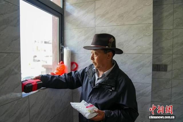 图为首批搬迁市民在新房摆放柴米油盐酱醋茶。中新社记者 刘冉阳 摄