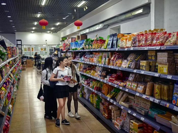 在国英超市里，3名吉尔吉斯斯坦女学生选购中国零食。刘洋 摄