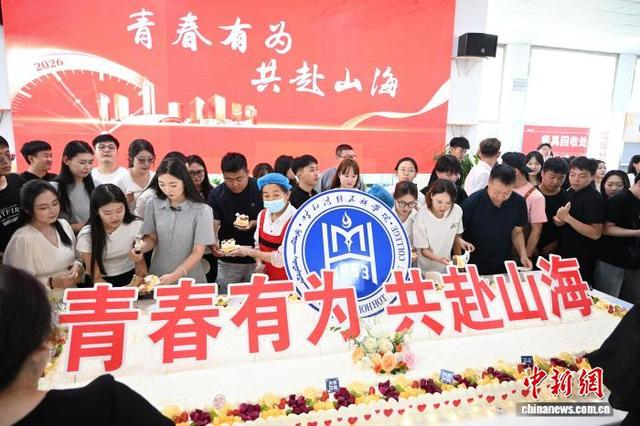 6月25日，内蒙古呼和浩特，毕业生品尝学校食堂为他们准备的蛋糕。中新社记者 刘文华 摄