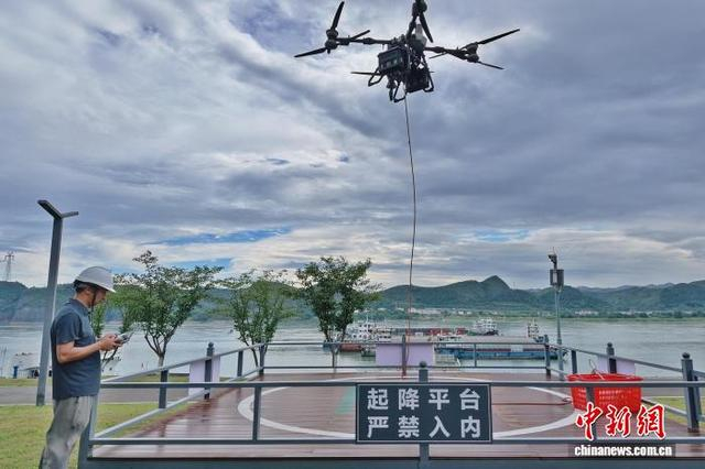 无人机操作员在长江岸边操作无人机送货。董晓斌 摄