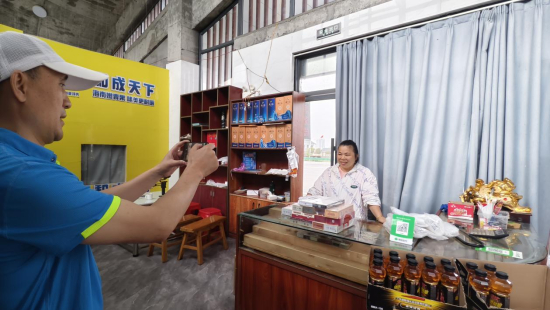 图为送货员正在使用手机终端完成无纸化电子签收