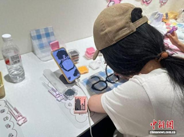 手作爱好者在创作心仪图案。 蓝伊旎 摄
