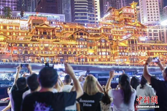 2024年9月28日，游客乘坐重庆“两江游”观光游船欣赏重庆夜景。 中新社记者 贾天勇 摄
