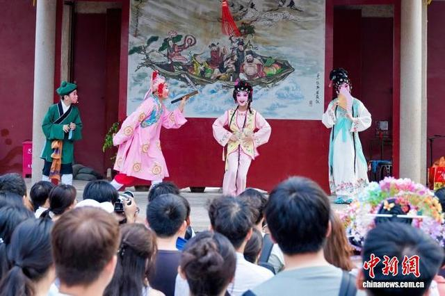 10月4日，市民游客在福建泉州天后宫观看由小朋友演出的梨园戏。中新社记者 孙虹 摄