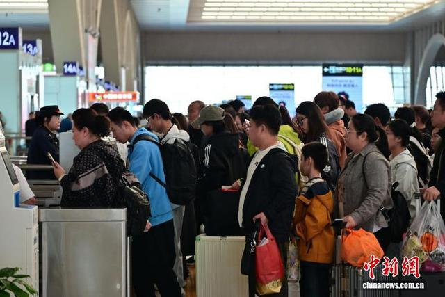 10月6日，河北石家庄火车站候车大厅，旅客排队进站。中新社记者 翟羽佳 摄