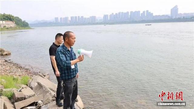 图为王龙贵沿江岸巡查。泸州市委宣传部供图