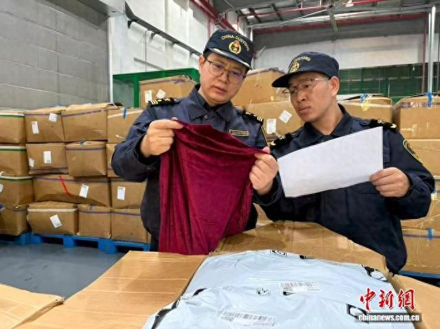 30日，松江海关关员对一批跨境电商出口服装开展查验。胡嘉晶 摄