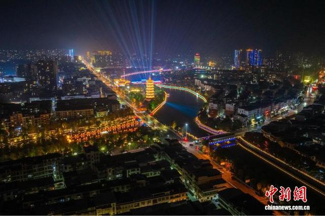 10月30日晚，在湖北省通城县“两河四岸”，灯火映碧波，人潮如织。图为通城县“两河四岸”光影交错，风景如画。张倩龙 摄