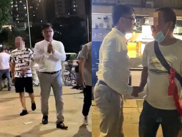 网传视频显示，21日晚何君尧与“白衣人”握手 视频截图