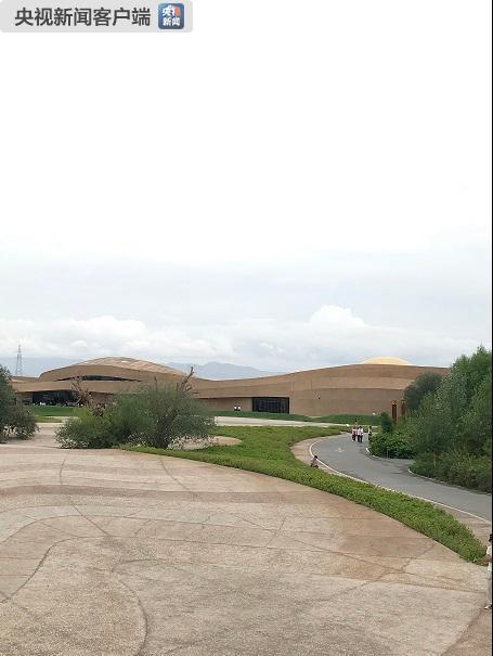 　　△莫高窟数字展示中心的设计理念是让建筑如同从大地中生长出来一般。建筑线条像风吹过沙丘一样婉转起伏，窗的设计有如洞窟。（央视记者石伟明拍摄）