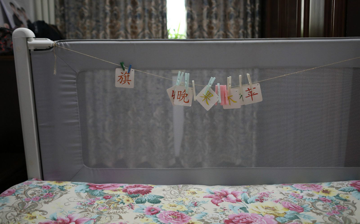  张英生前育有一女，梦梦（化名）如今已经两岁多，汤玉娥在床头挂起了识字卡片。 新京报记者 王飞 摄