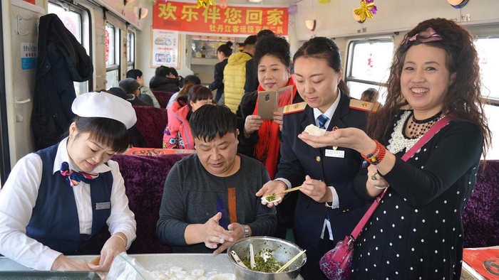 △牡丹江客运段列车乘务员与旅客一起包饺子