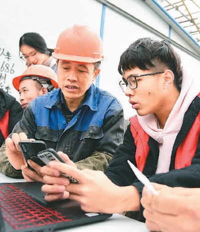 　　2019年12月23日，江苏大学志愿者走进镇江市官塘桥街道远洋社区辖区建设工地，向外来务工人员传授互联网订购春运车票技能，提供网上购票服务。 　　石玉成（人民视觉）