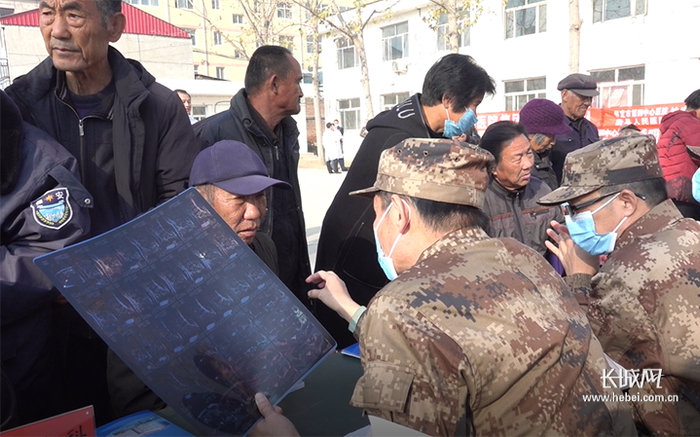 义诊现场，当地居民在认真聆听医疗队专家的解答。长城网记者 王岚 摄