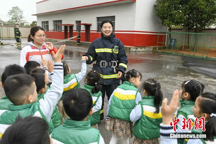 幼儿园的小朋友参观消防演练，彭娟担任讲解员。杨华峰 摄