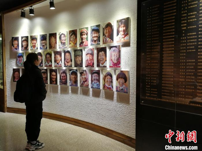 图为独龙族博物馆的文面女照片墙。　胡远航 摄