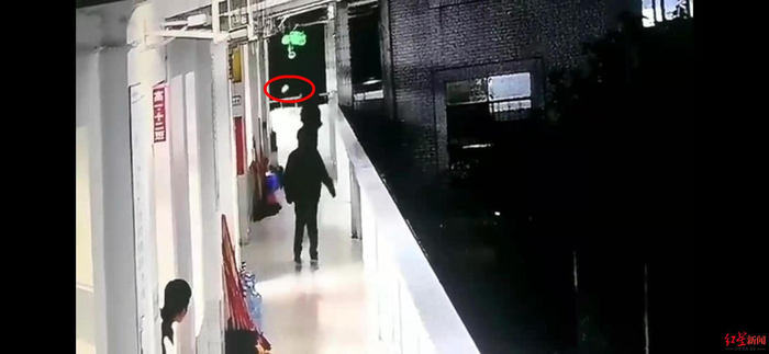 女生（红圈处）跳楼瞬间 视频截图