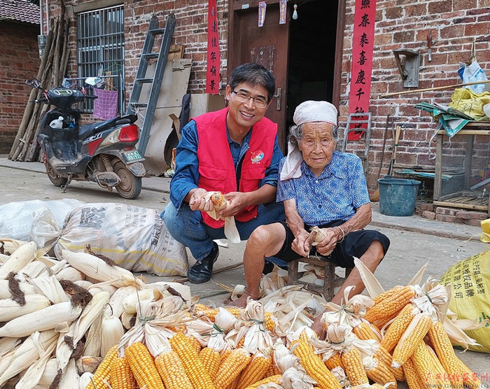 李守亭在汪淋屯入户走访，与94岁的老奶奶一起剥玉米