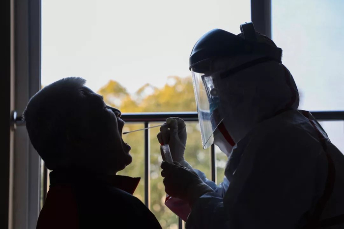  医生在给患者做核酸检测。（远征 摄）