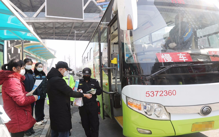 818路公交车安保人员逐站逐人进行体温检测并登记。新京报记者 王贵彬 摄