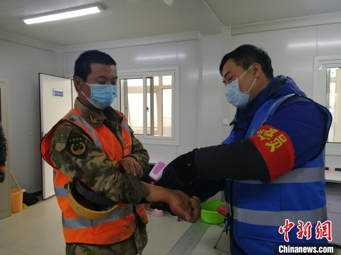 卫生监督员对上岗工人进行体温监测。　主办方供图 摄