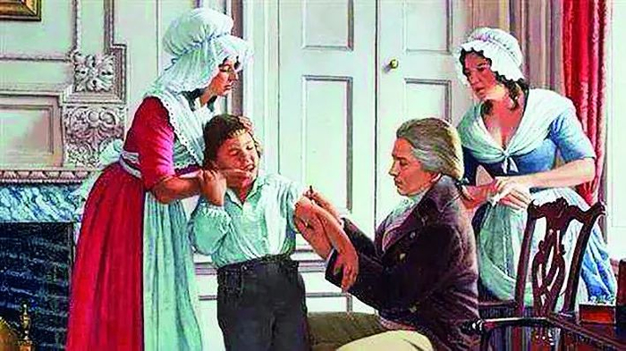 ·油画作品所表现的詹纳为小男孩接种牛痘的场景。