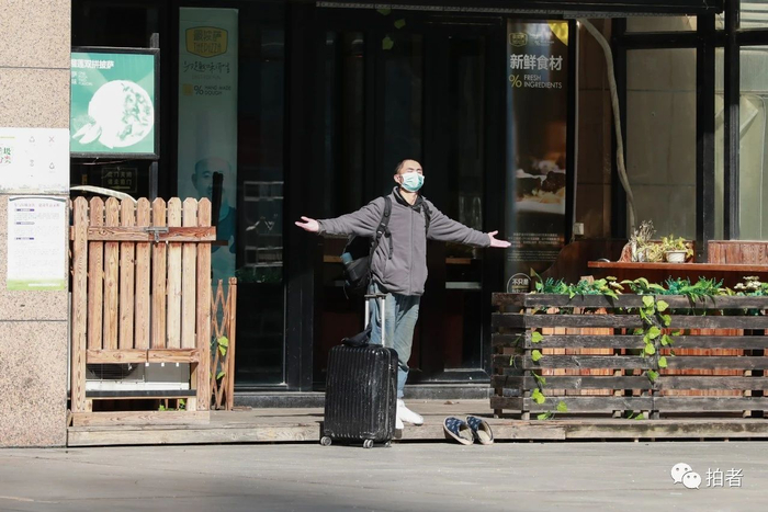 △&nbsp;江汉区花楼街，雪后初晴，一名行人张开双臂享受阳光。摄影/中青报·中青网记者鲁冲