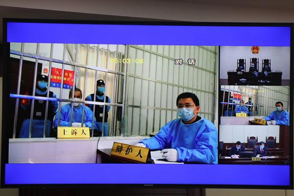互联网远程庭审系统庭审现场画面。九江市中级人民法院 图