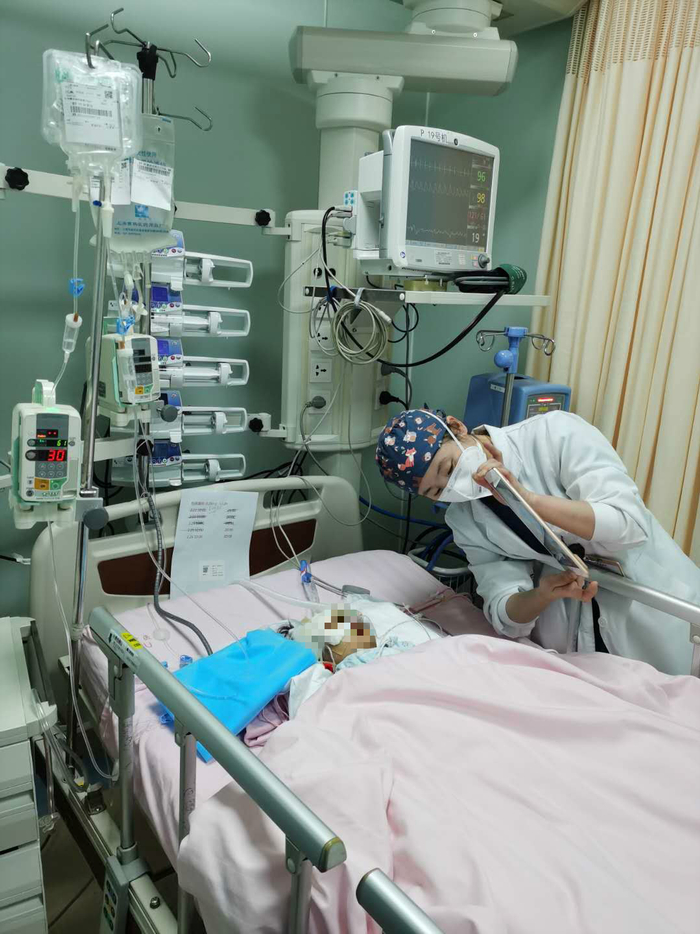 医护人员拿着IPAD让患儿与家长进行远程视频通话。&nbsp; 上海市儿童医院供图