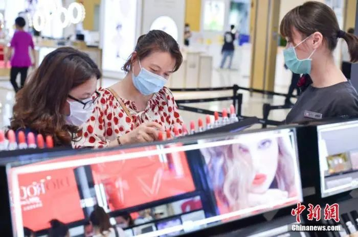 2月27日，民众佩戴口罩在海口日月广场免税店选购免税商品。 骆云飞 摄