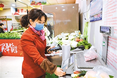 2月5日，重庆百货云阳超市工作人员在按照网上订单称重。 　　新华社记者 王全超摄