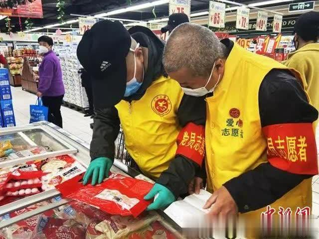 兰州市七里河区“红色代跑队”志愿者正在结合清单核对所购物品。高康迪 摄