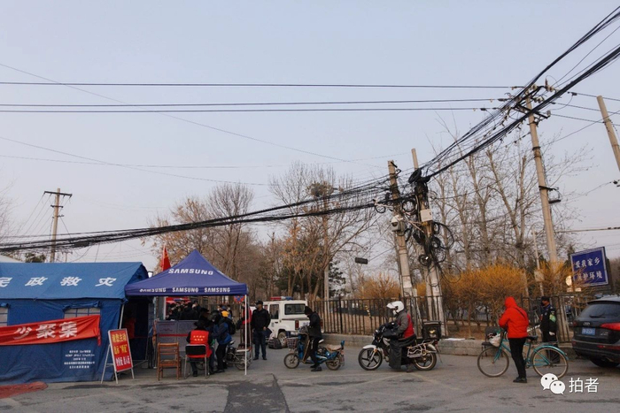  △&nbsp;2月25日，村里原先的三个出入口暂时被封闭了两个，居民在由防疫人员24小时值守的唯一出入口排队进村。