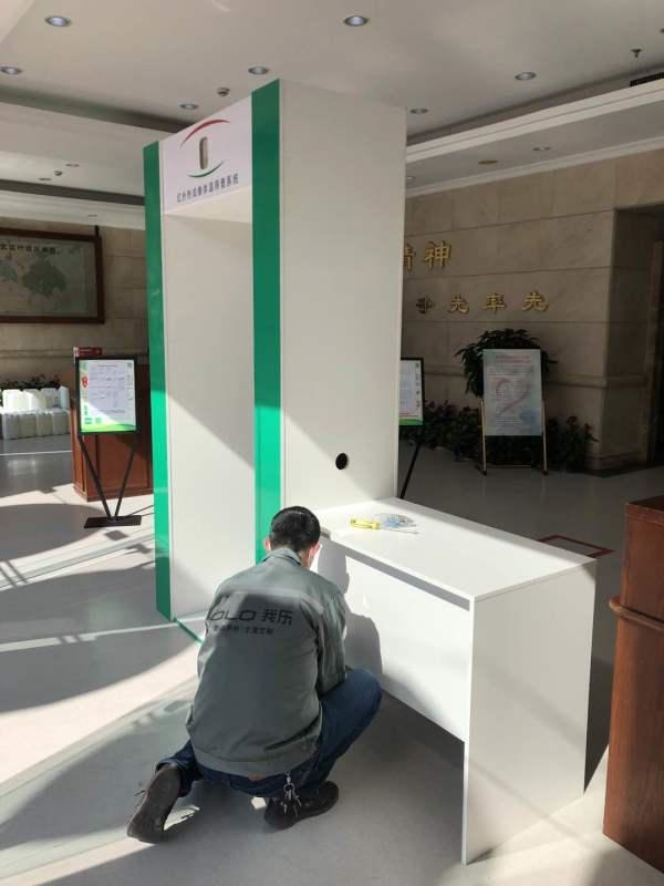 (图：我乐家居员工安装体温筛查安检门)