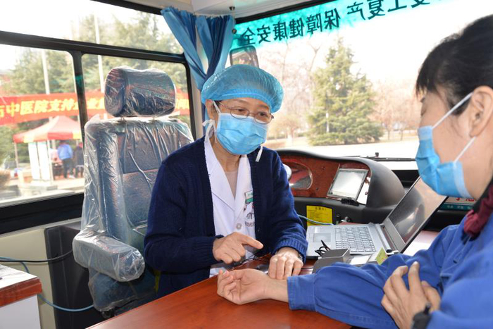 河北省名中医、石家庄市中医院心病科专家于慧卿在为河钢集团石钢公司职工号脉。