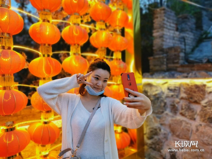 游客在小镇的美景下自拍。胡晓梅 摄