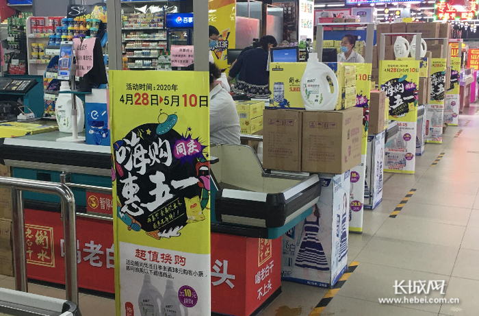 万德福超市前进大街店，收银台处张贴促销海报。实习记者卢婉凤 摄