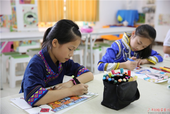 毛南族学生正在用心画“廉”画