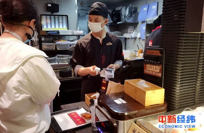 餐厅工作人员在检查健康码 中新经纬 张燕征 摄