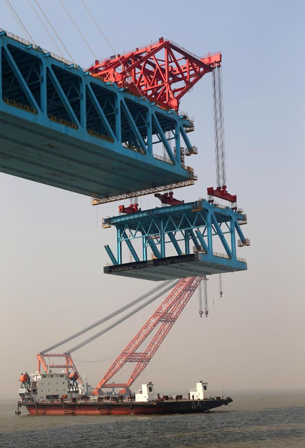 图为施工人员在进行沪苏通长江公铁大桥主航道桥28号墩的大节段钢梁悬吊。（新华社 丁晓春 摄）