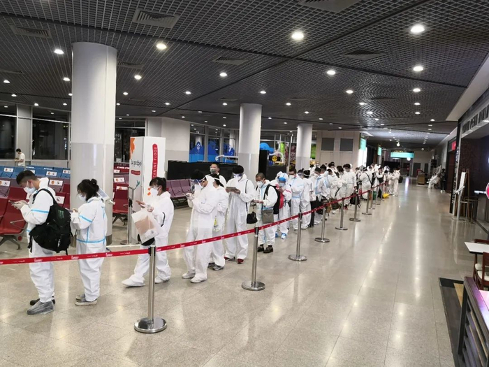 ↑乘客们正在安静有秩序的排队办理手续。张保 摄