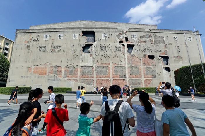 　　8月23日，随着电影《八佰》热映，连带着真实历史事件的发生地——上海四行仓库纪念馆迎来了参观客流高峰。人们在谢晋元纪念广场上驻足，与弹孔墙留影。摄影/本刊记者 张亨伟