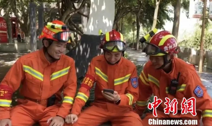 图为清淤休息间隙，余路遥叫来队员一起翻译“家书”。谢金彬 摄